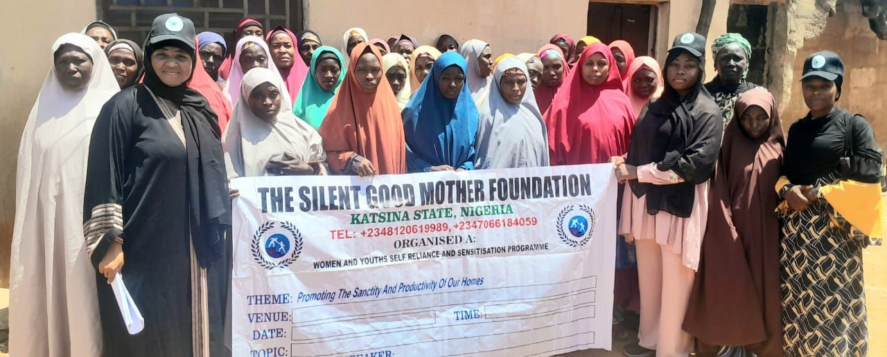 Women gathered behind a Silent Good Mother Foundation banner at a women and youth self-reliance programme